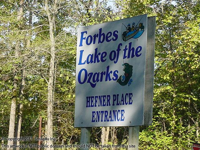 The sign marking the entrance road to Hefner Place, where this property sits, in rustic Forbes Lake of the Ozarks near Osage Beach, Missouri
